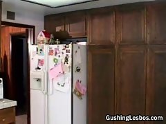 Lesbian dildo fucking in the kitchen